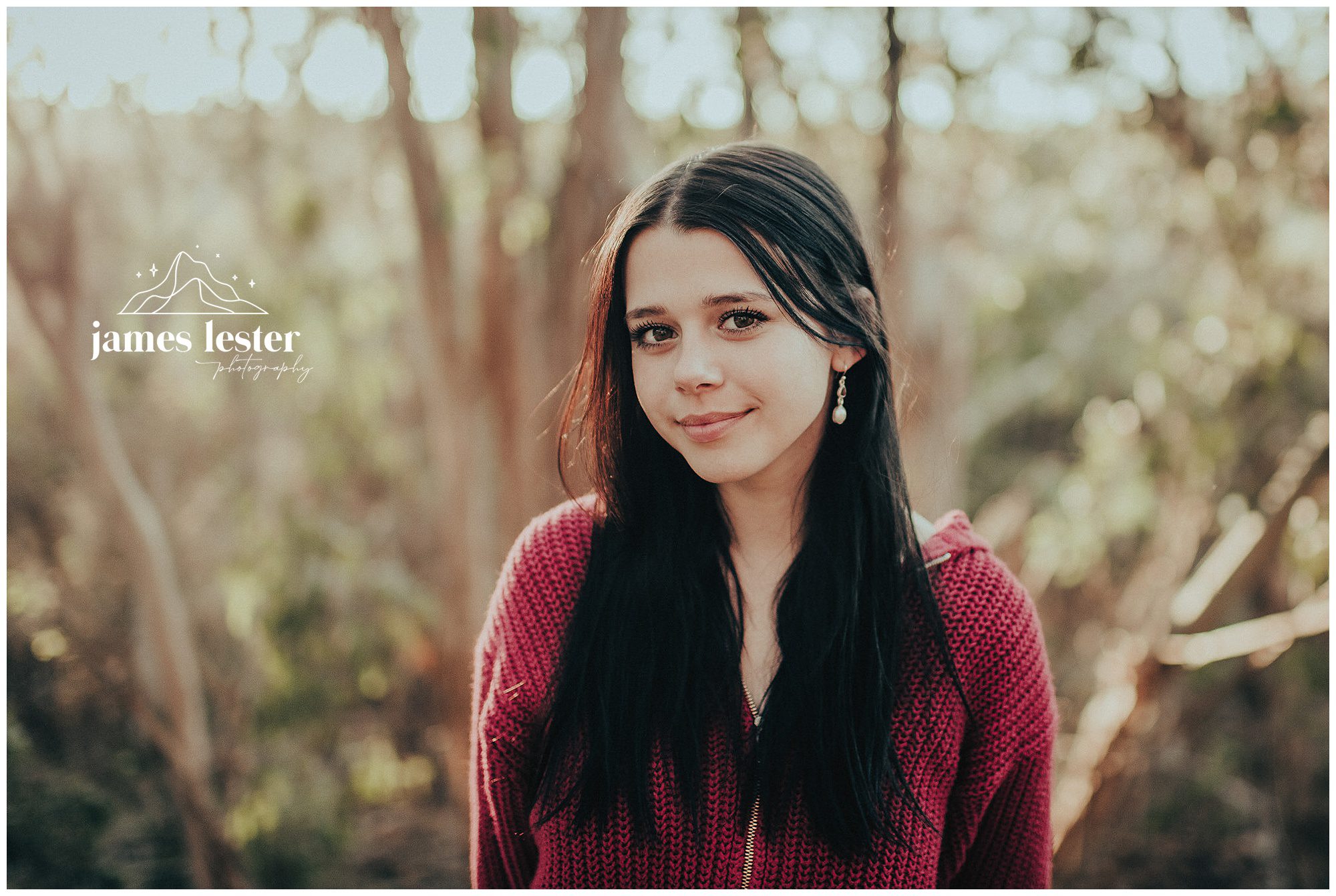 Close senior portrait in soft forest light