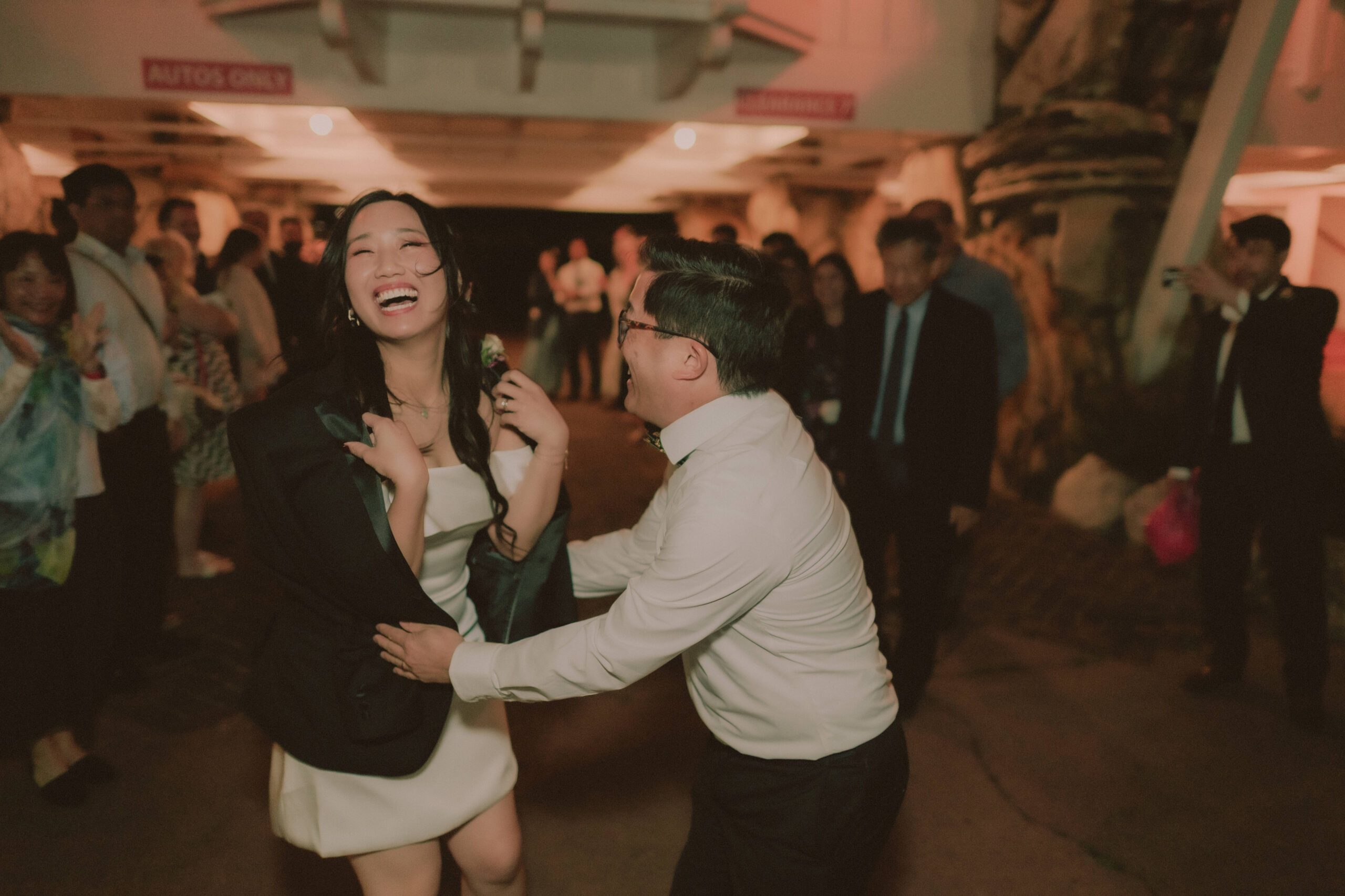Alice and Ryan laughing together on the reception dance floor