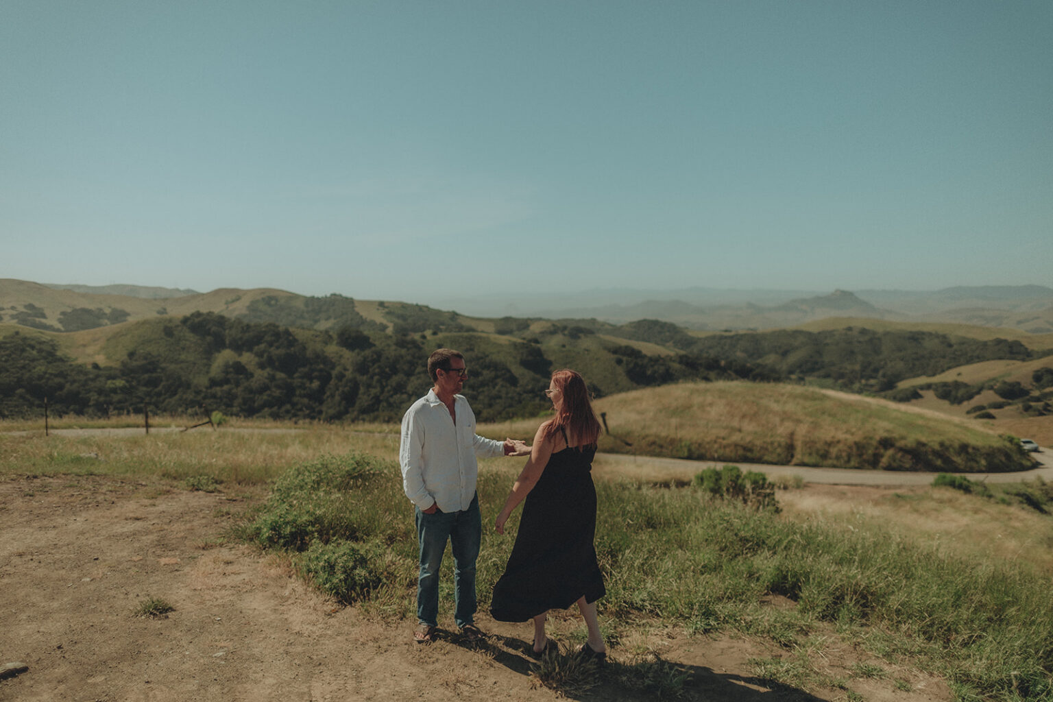 Couple walking together outdoors during an engagement session
