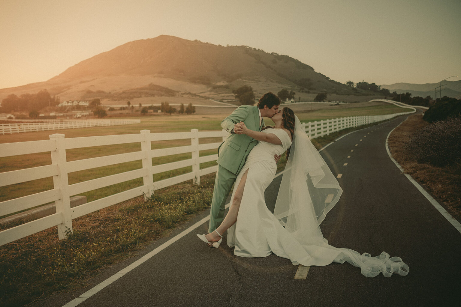 Newlyweds walking at sunset near the Madonna Inn