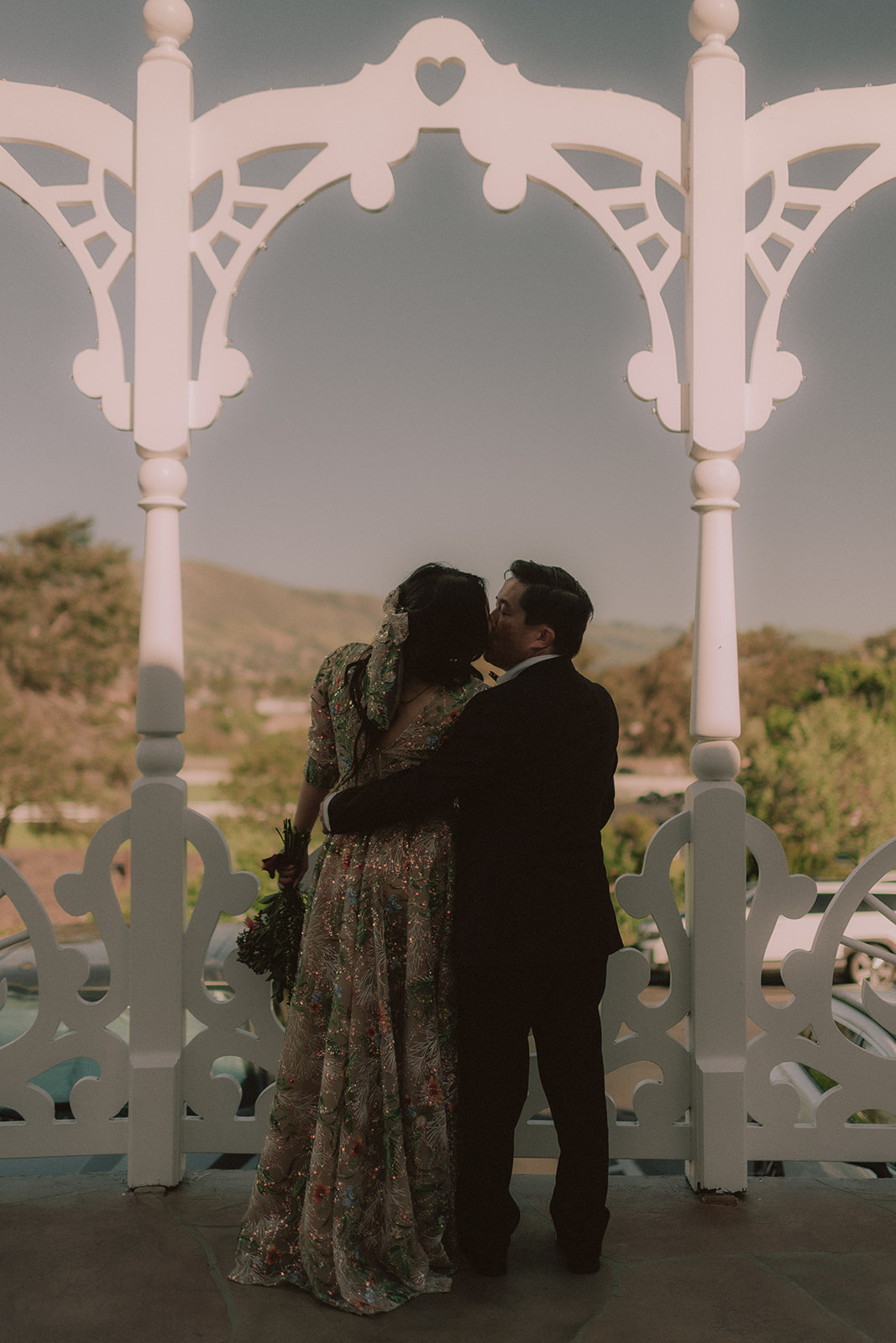 Moody silhouette of a couple beneath Madonna Inn architecture