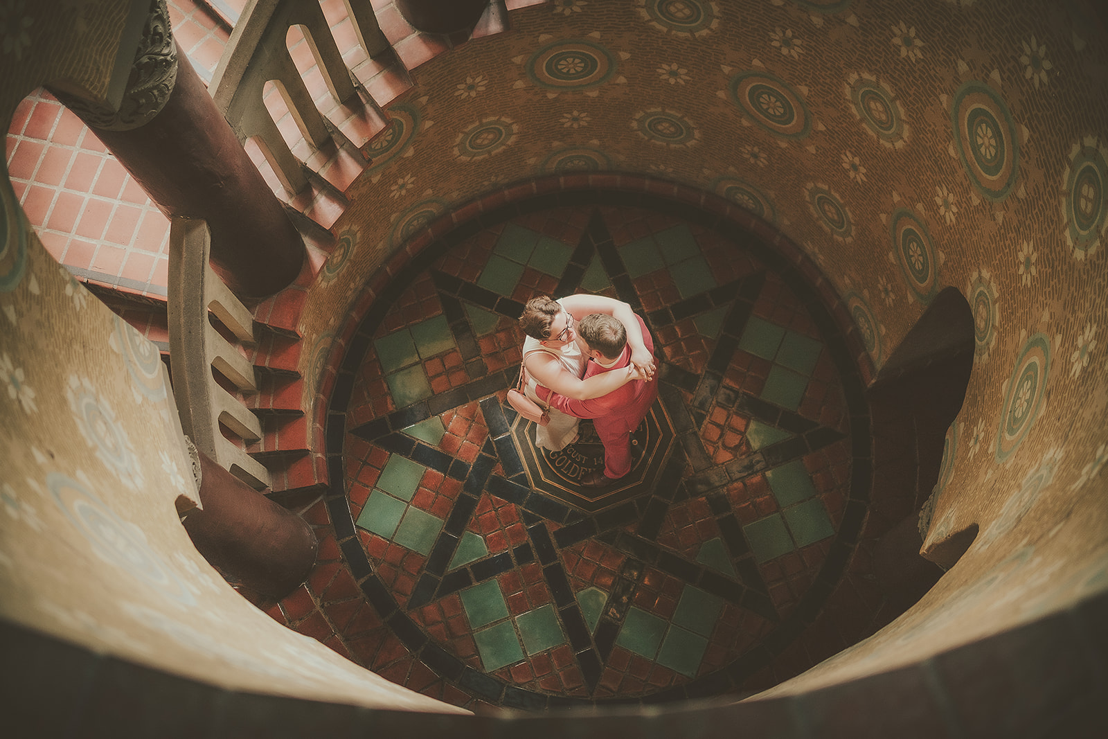 Creative overhead portrait of a couple on the courthouse spiral staircase