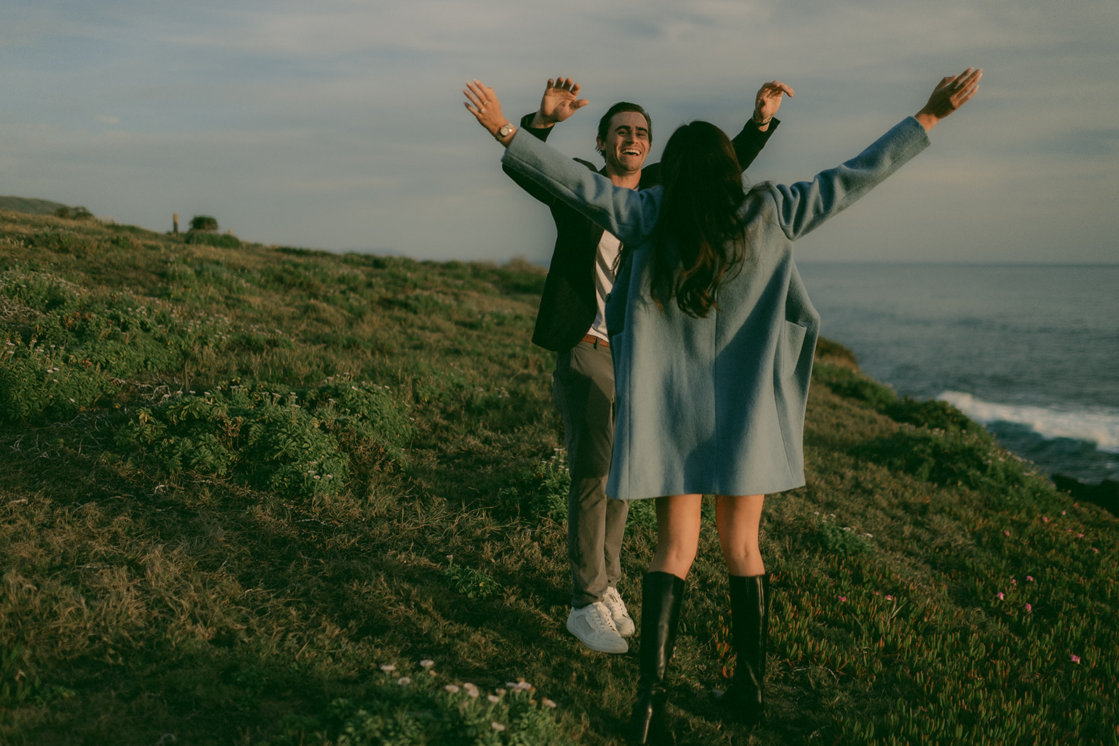 Joyful arms-up celebration immediately after saying yes