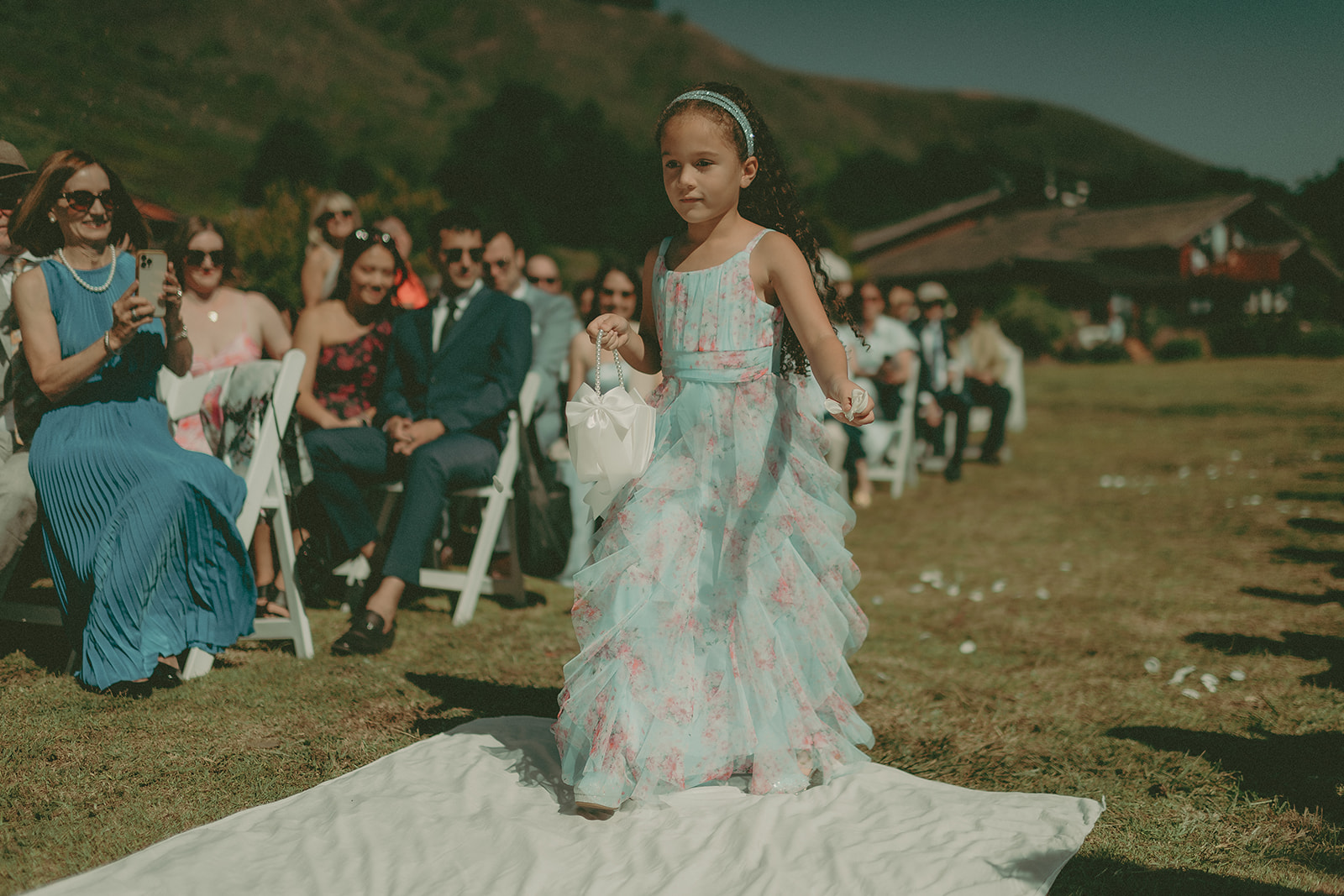 Bride moving through the ceremony aisle at a coastal wedding