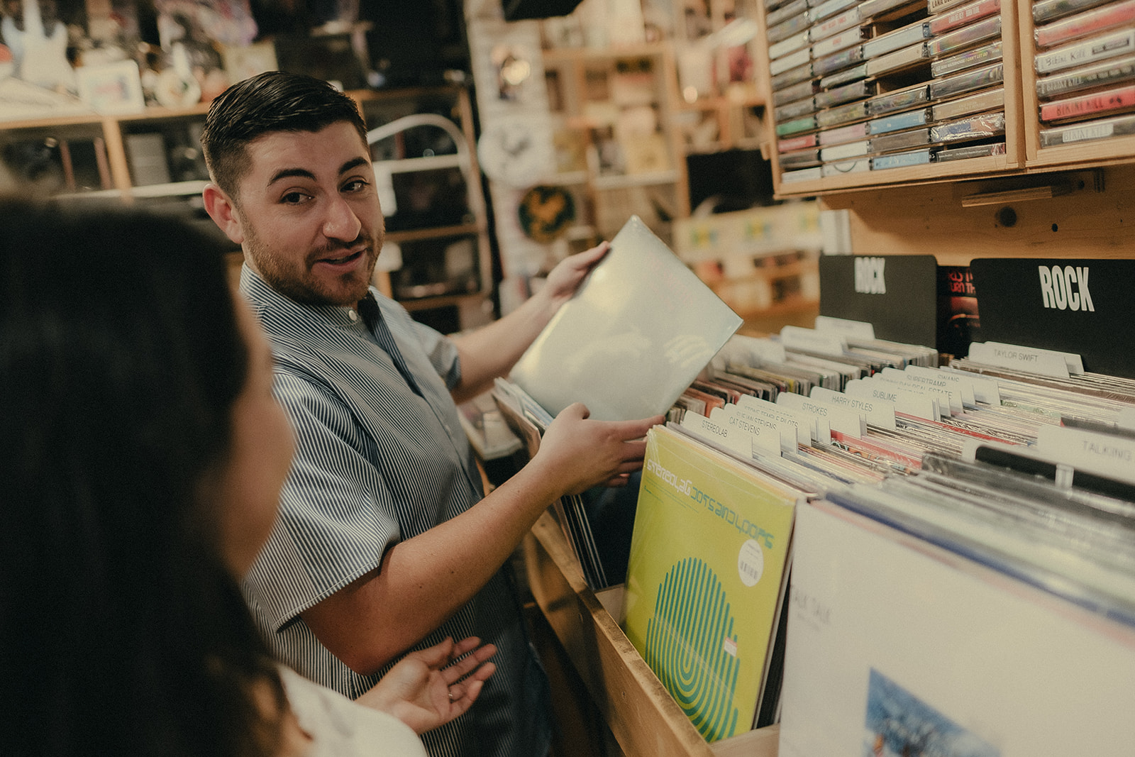 Couple browsing records together during their engagement session