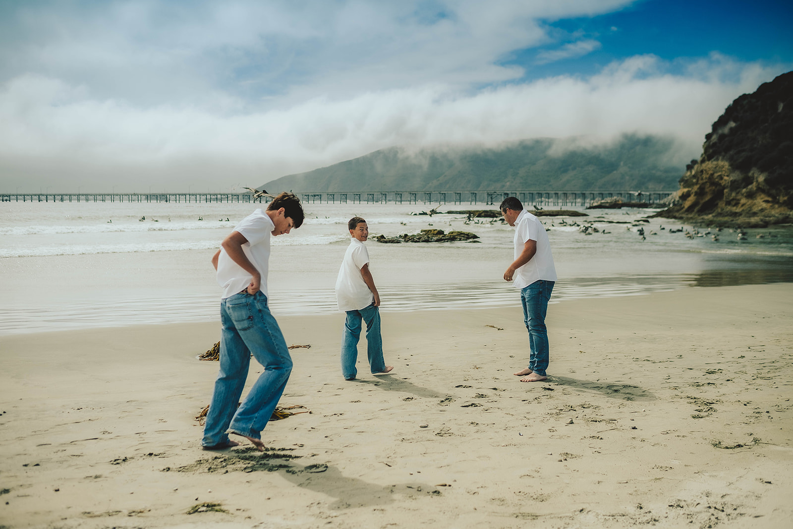 Family running and playing together along the beach