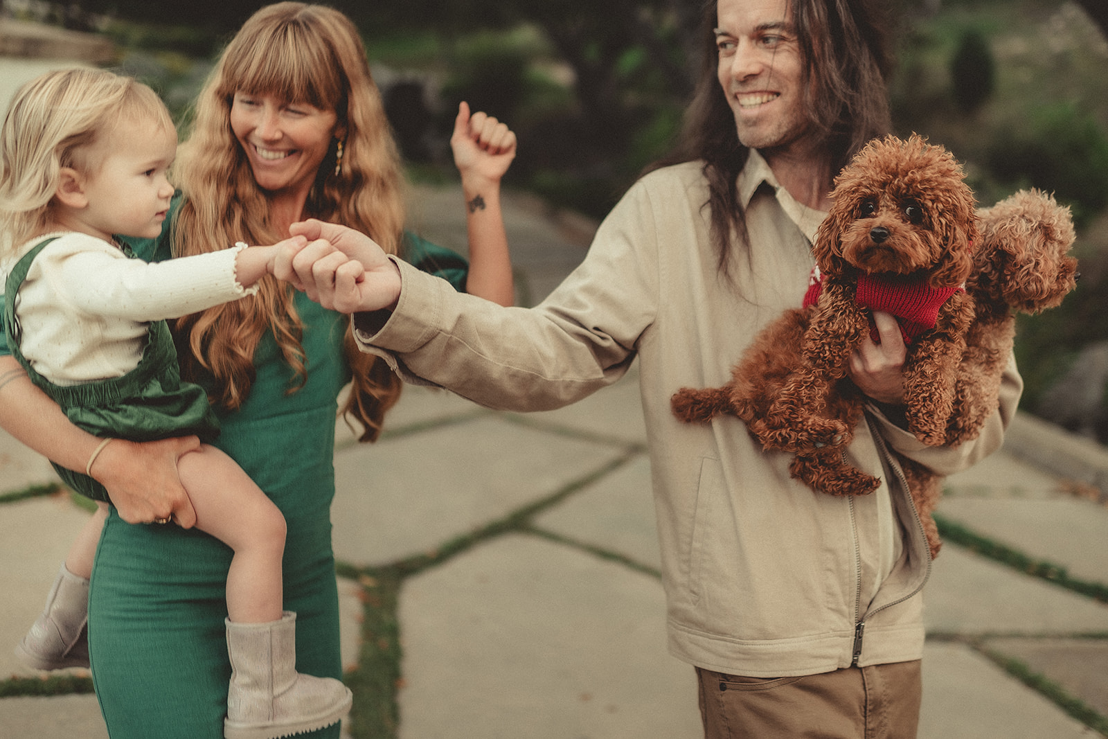 Child and adult sharing a playful moment with the family dog