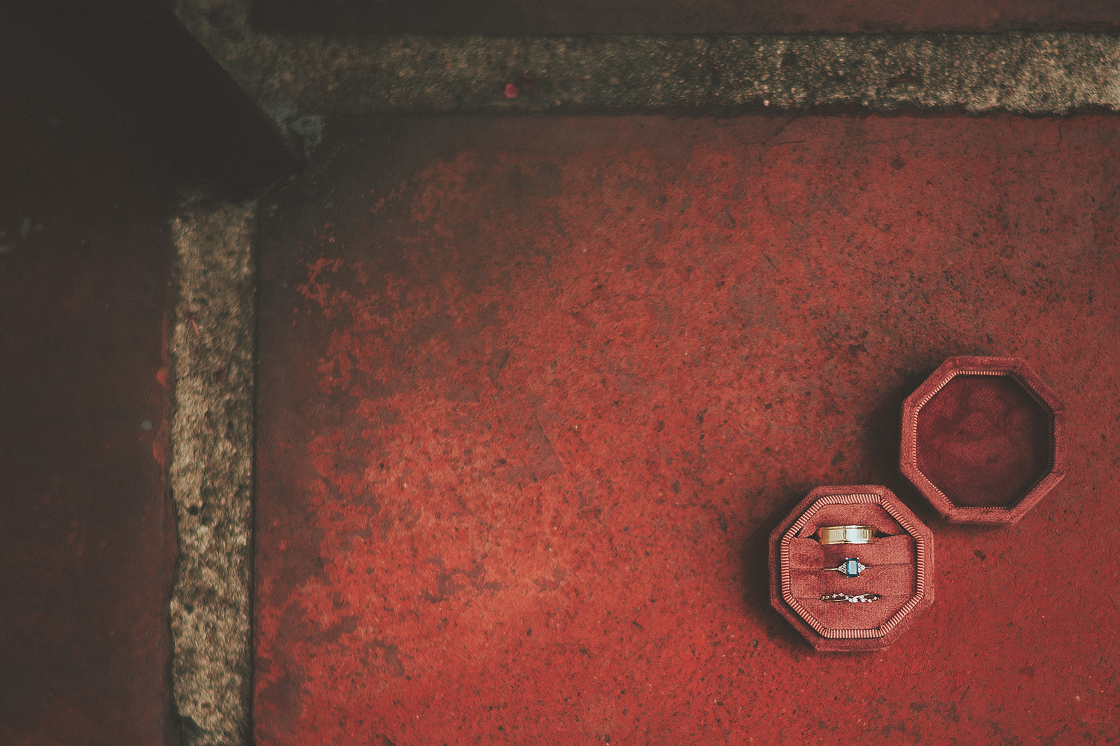 Wedding rings photographed on a warm red courthouse detail