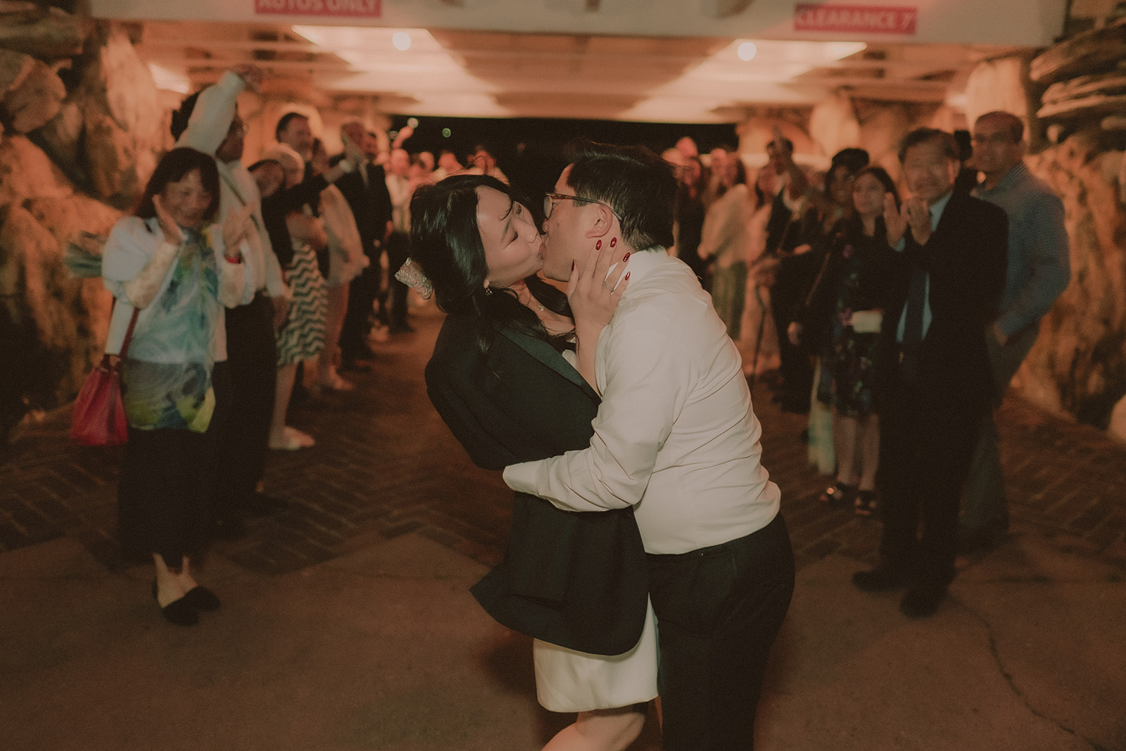 Newlyweds and guests celebrating together on the dance floor