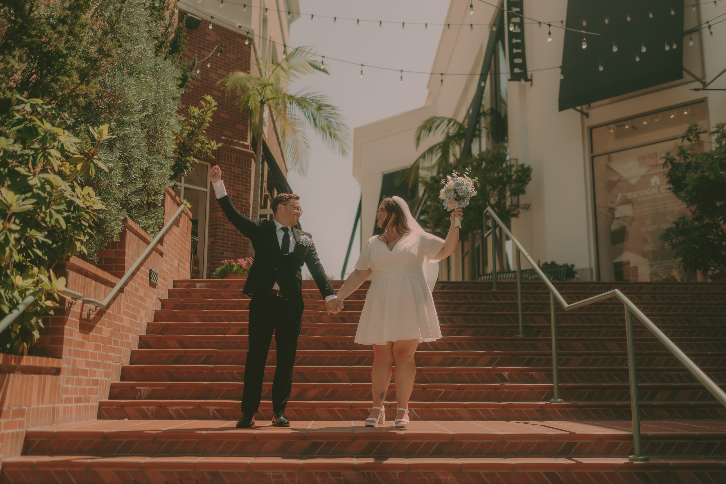 Tiffani and Braden pose on a wide brick stairway in downtown San Luis Obispo.