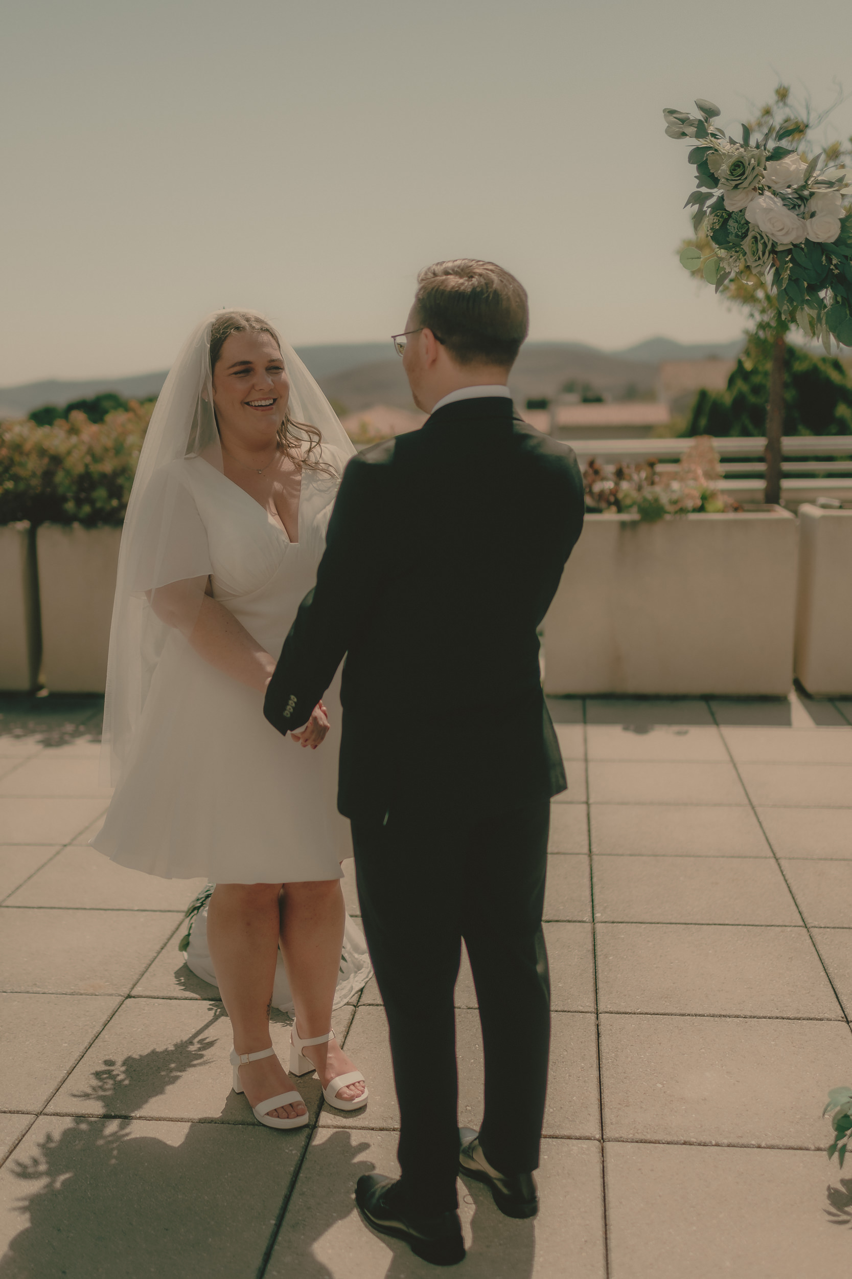 Tiffani smiles at Braden during their rooftop vows.