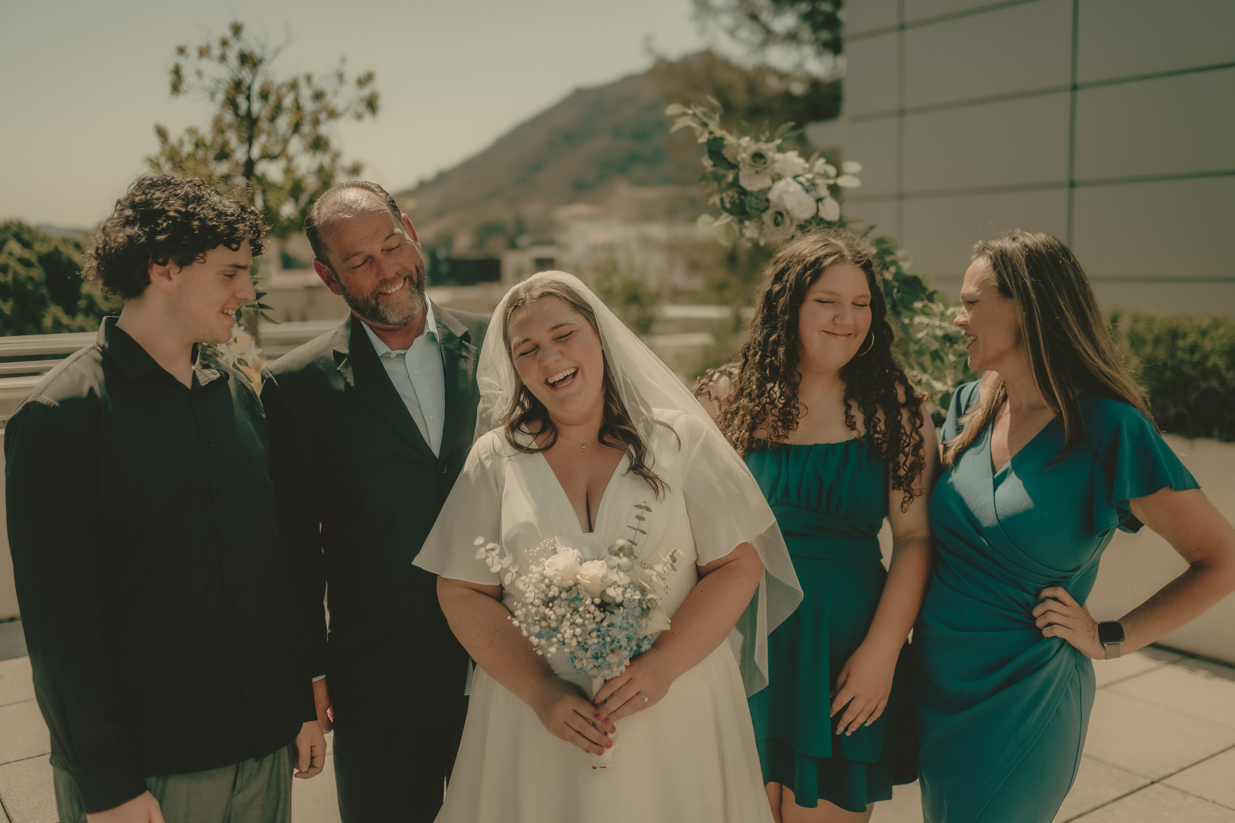 Tiffani laughs with guests after the rooftop courthouse ceremony.