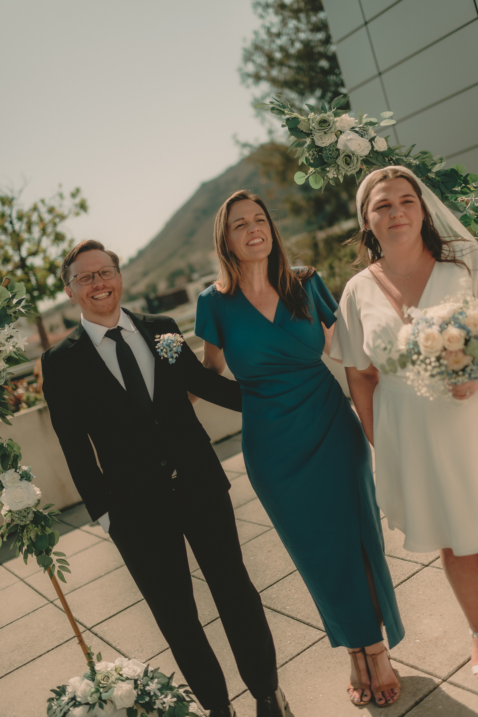 Tiffani and Braden pose playfully with a guest.