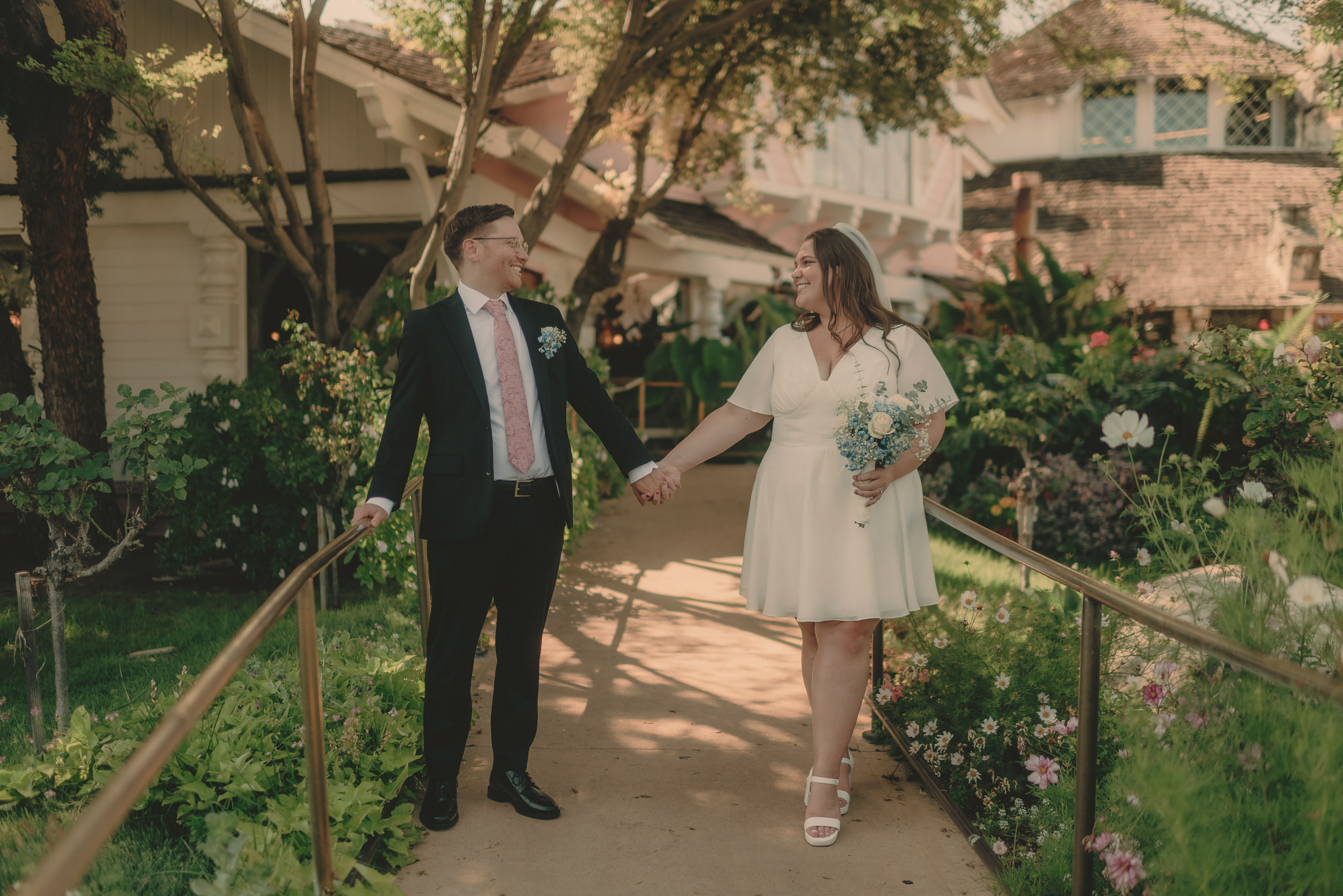 Tiffani and Braden walk hand in hand through the Madonna Inn gardens.