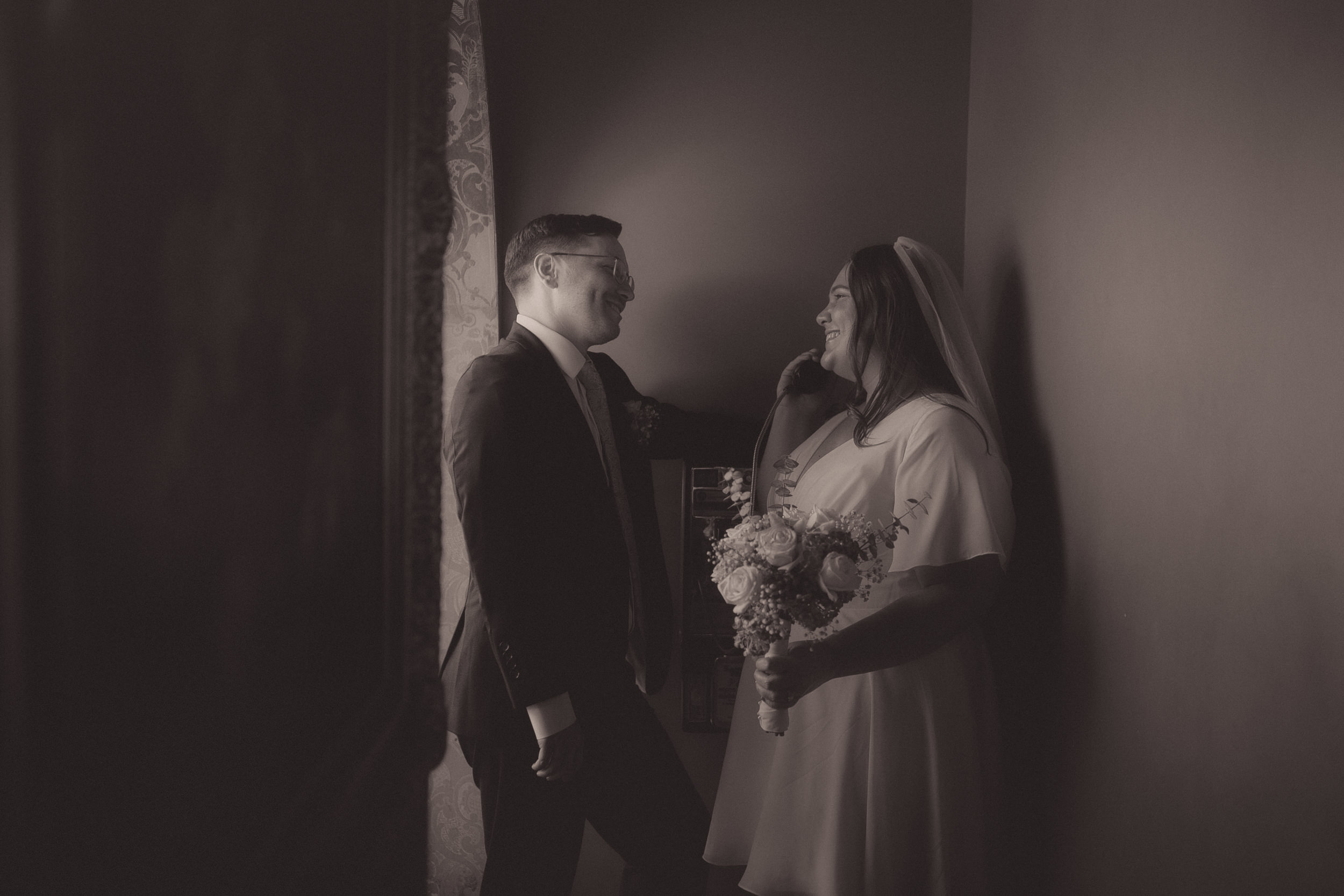 Tiffani and Braden pose together in a moody black-and-white Madonna Inn portrait.