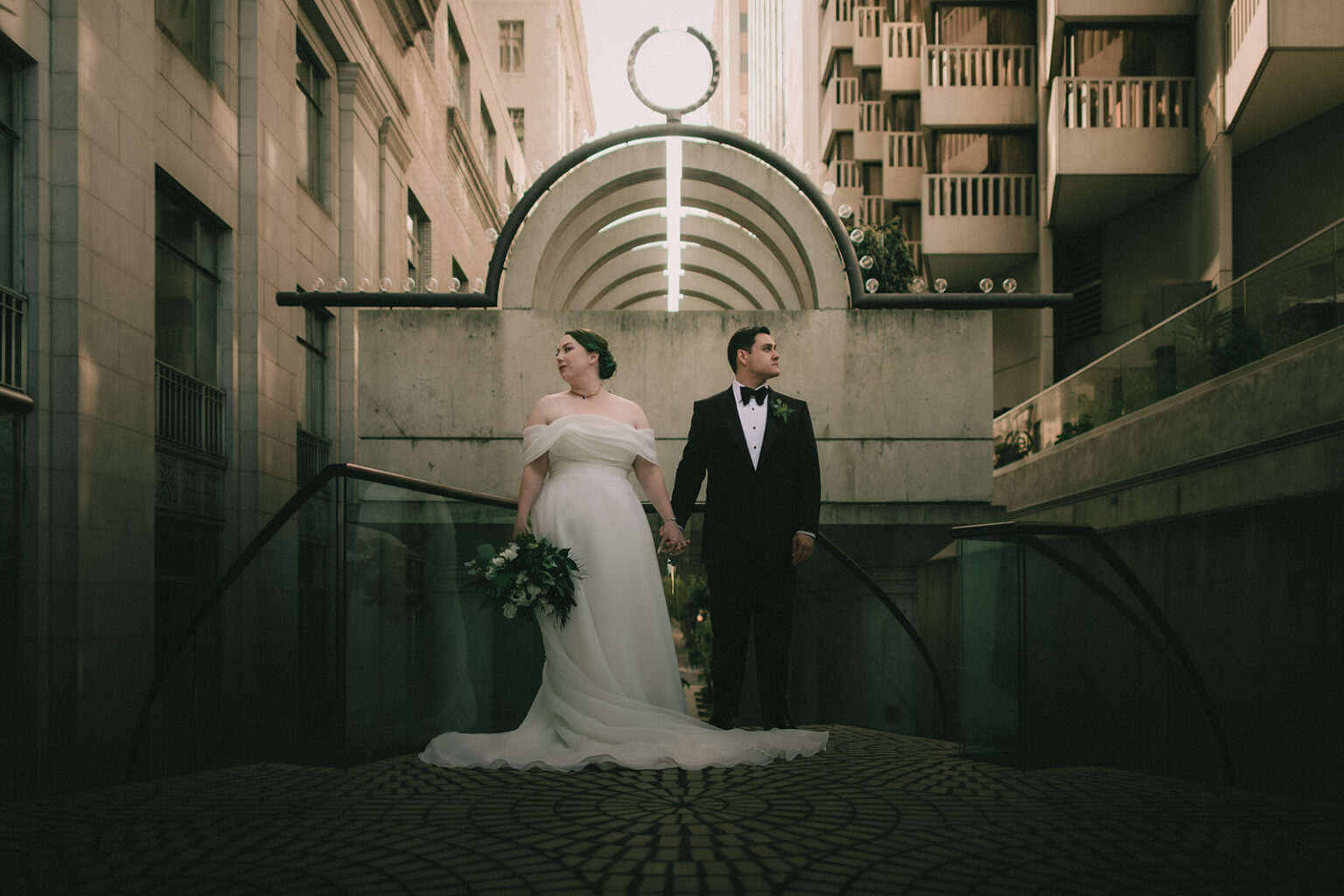 Anne and Charles beneath geometric San Francisco architecture