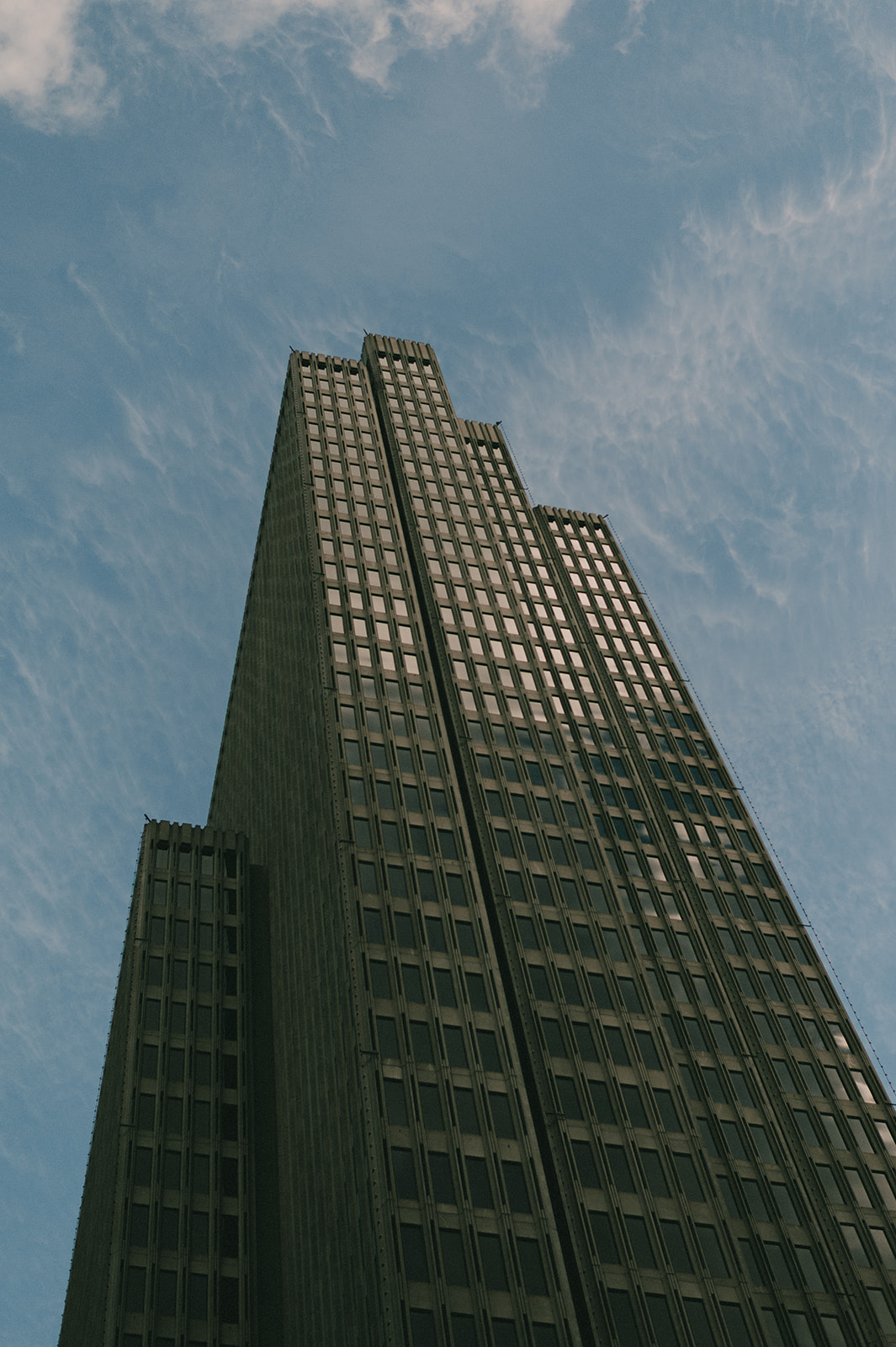 Low-angle view of the historic Merchants Exchange Building against a blue San Francisco sky.