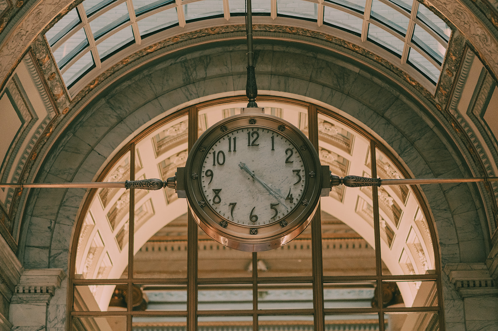 Close architectural portrait of the Julia Morgan Ballroom's historic clock and marble arch.