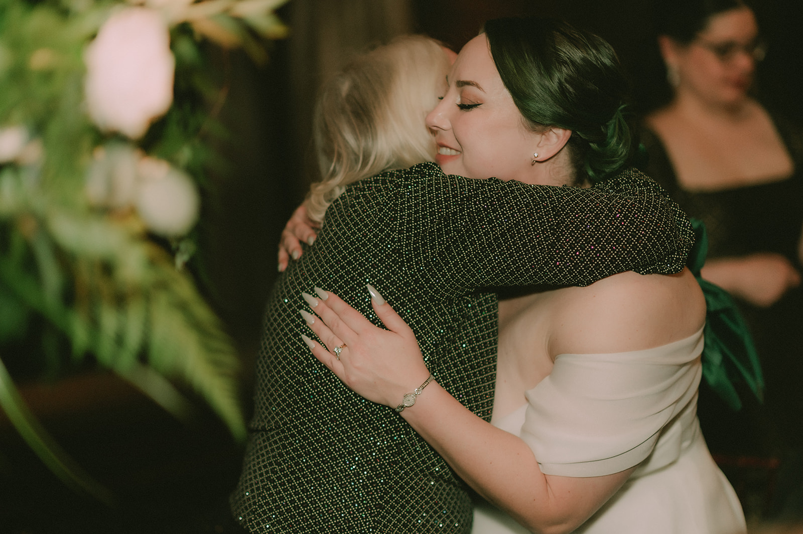 Anne closes her eyes during an emotional hug with a wedding guest.