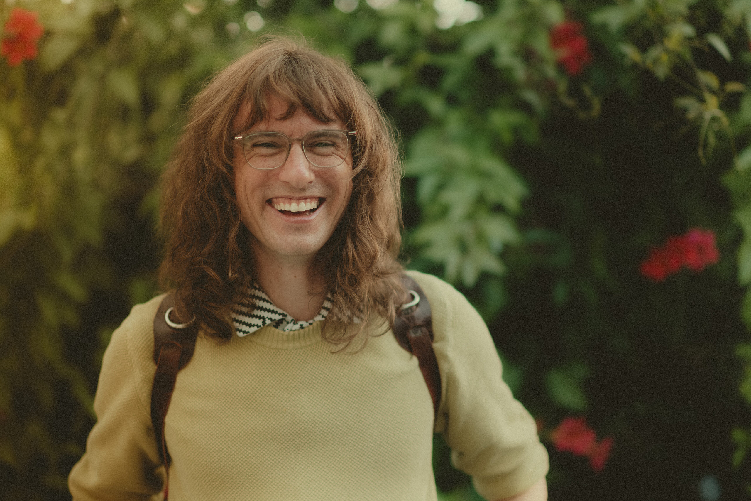 James Lester laughing in warm outdoor light.