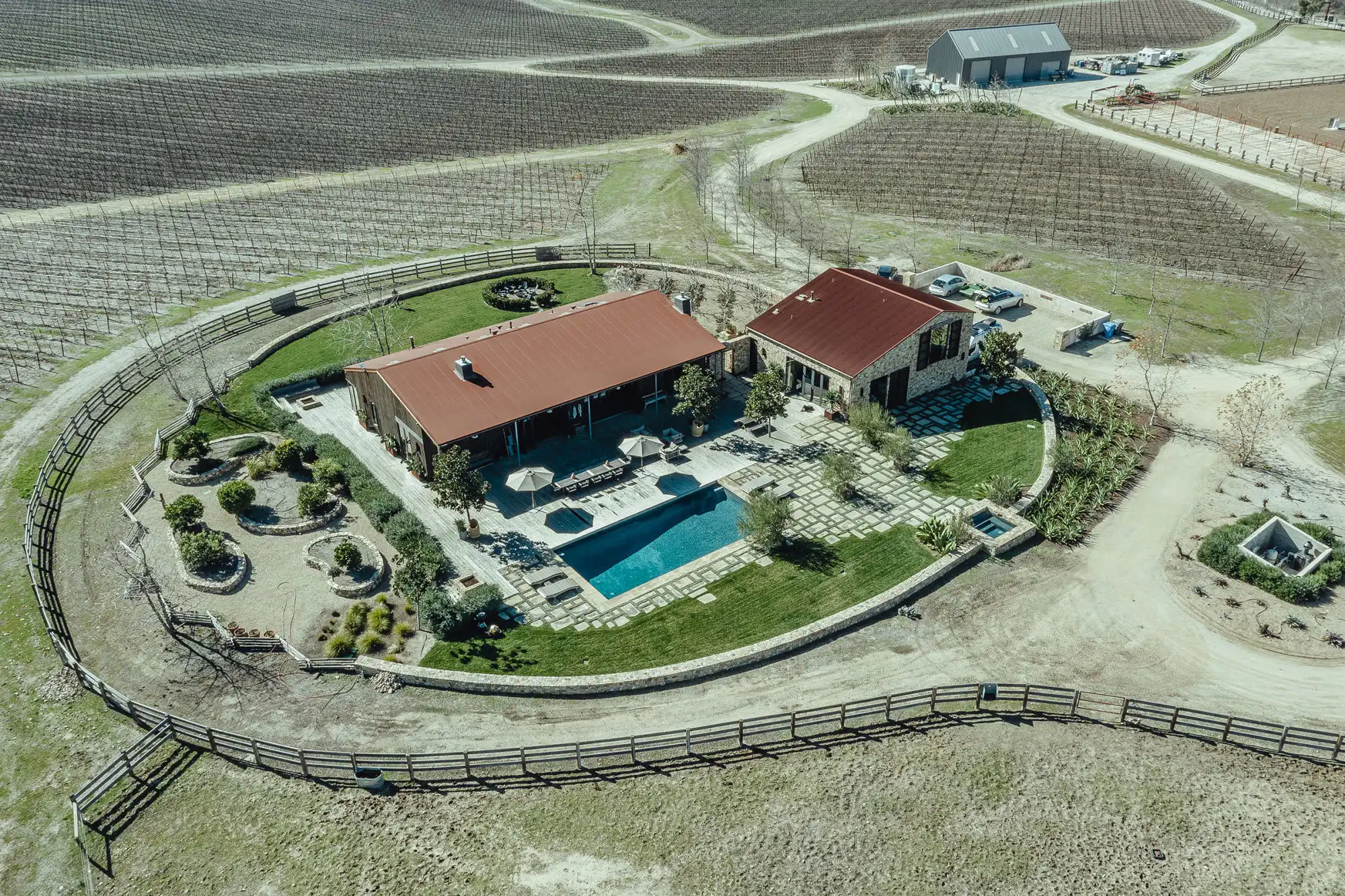 Aerial view of MarFarm with its pool, landscaped grounds, and surrounding vineyards