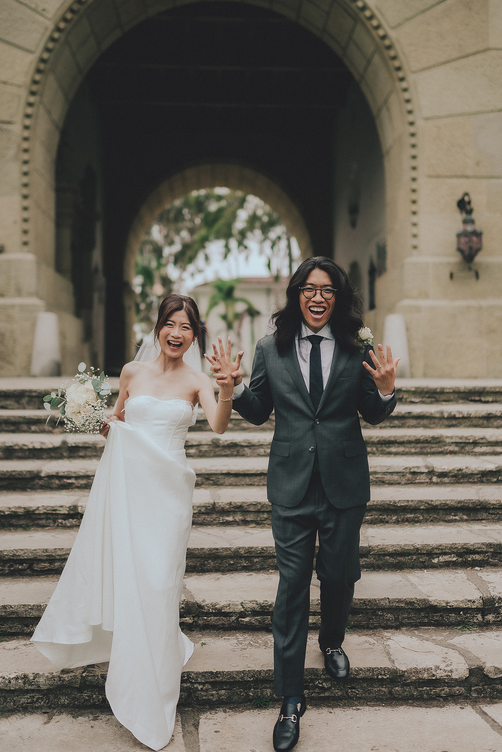 Tina and Kendrick celebrating beneath the courthouse arch